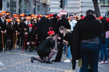 PORTO, PORTUGAL - MAY 3, 2022: During Cortejo Queima das Fitas - annual festivity of Portuguese students of universities. The graduates wear a top-hat and a walking-cane, both colour of their Faculty.