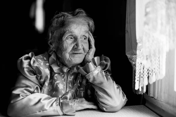 Portrait of an old woman, black and white photo.