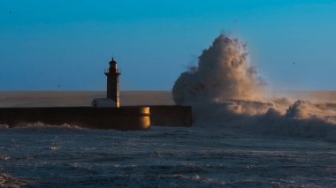 Lighthouse with huge wave at Atlantic ocean in Porto, Portugal.