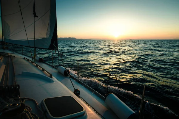 Sailing yacht boat in the Sea during amazing sunset.