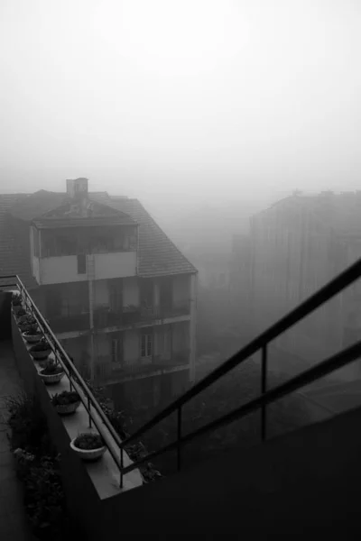 A foggy neighborhood in the early morning in Porto, Portugal. Black and white photo.