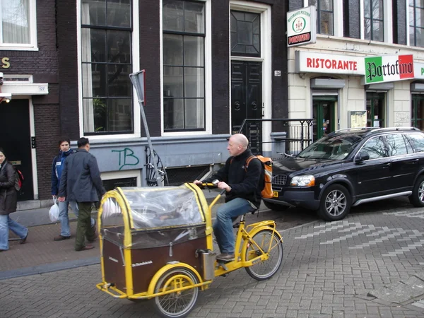 The Netherlands, Amsterdam. Typical Amsterdam city view with a bicycle rider. March, 2008. — Stock Photo, Image