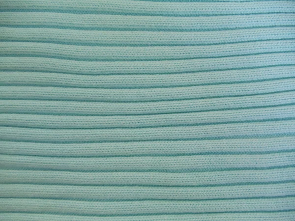 Background. A turquoise knitted fabric with a seamless pattern. — Stock Photo, Image