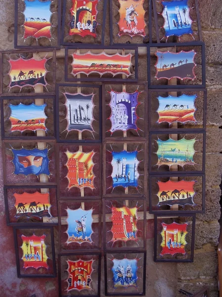 Background. Crafts. Street exhibition of souvenir pictures with moroccan motif.Essaouira, Morocco. January, 2013. — Stock Photo, Image