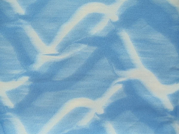 Background. Close-up. Artificial blue and white silk with a seamless abstract pattern. — Stock Photo, Image