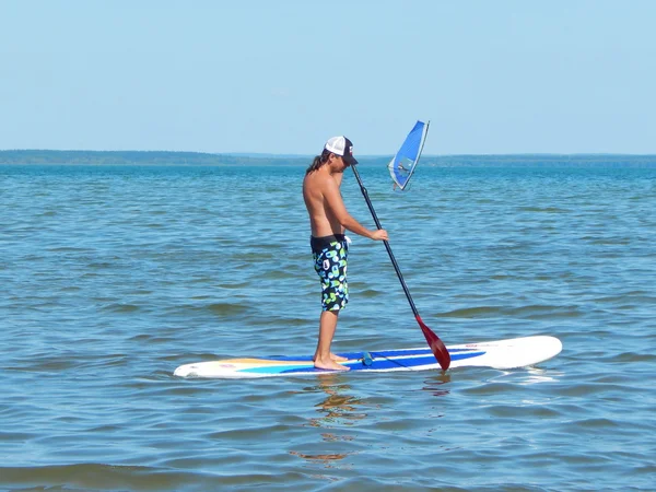 Stand up paddle surfing. Sport activity and rest. At the Plescheevo lake near Pereyaslavl-Zalessky, Russia. August, 2014. Stock Photo