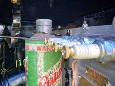 Under the bonnet of a Morris 8 showing the spare oil and spark plugs
