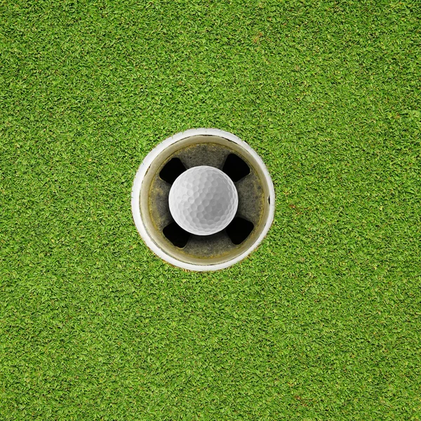 Golf ball in hole — Stock Photo, Image