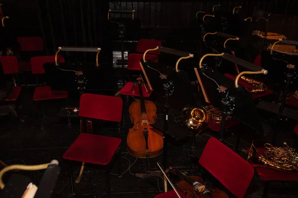 Cello and  French Horn on chair during interval  in theatre