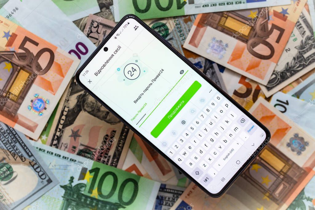 Kyiv, Ukraine - December 1, 2021: smartphone screen with mobile banking Privat24 application on US dollar and euro banknotes background