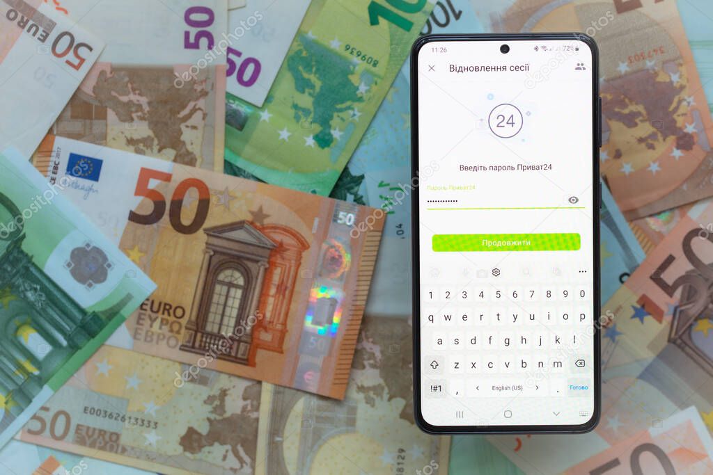 Kyiv, Ukraine - December 1, 2021: smartphone screen with mobile banking Privat24 application on euro banknotes background