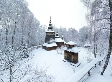 Lviv, Ukrayna - 8 Aralık 2021: Lviv 'deki Klymentii Sheptytskyi Halk Mimarisi ve Kırsal Yaşam Müzesi (Shevchenkivskyi Hai)' deki antik köy ahşap kilisesi. Kışın Skansen