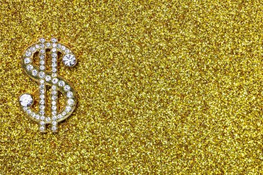 golden dollar sign with gemstones on yellow glitter background for design purpose