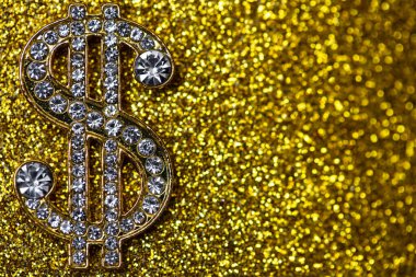 golden dollar sign with gemstones on yellow glitter background for design purpose