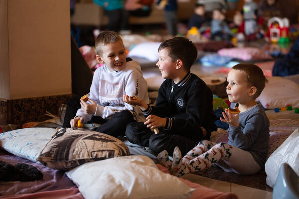 Lviv, Ukraine - March 11, 2022: Ukrainian refugees on Lviv railway station during russian war. Refugee kids in waiting hall