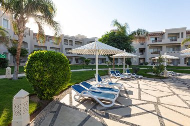 Hurghada, Mısır - 1 Ekim 2019: Mısır 'ın başkenti Hurghada' daki Jaz Casa Del Mar Resort 'ta güneşlik şemsiyeler ve güneşlik yatakları