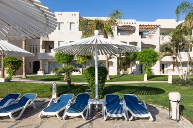 Hurghada, Mısır - 1 Ekim 2019: Mısır 'ın başkenti Hurghada' daki Jaz Casa Del Mar Resort 'ta güneşlik şemsiyeler ve güneşlik yatakları