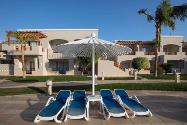Hurghada, Mısır - 1 Ekim 2019: Mısır 'ın başkenti Hurghada' daki Jaz Casa Del Mar Resort 'ta güneşlik şemsiyeler ve güneşlik yatakları