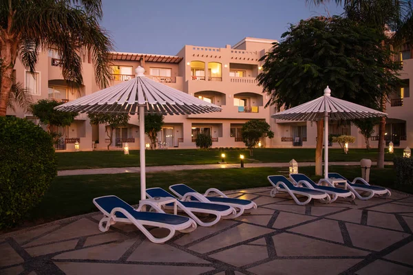 Hurghada, Egypt - October 1, 2019: sunshade umbrellas and sunbeds near pool in Jaz Casa Del Mar Resort in Hurghada, Egypt