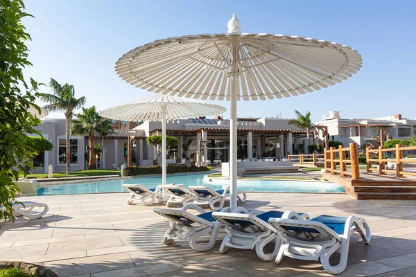 Hurghada, Mısır - 1 Ekim 2019: Mısır 'ın başkenti Hurghada' daki Jaz Casa Del Mar Resort 'ta güneşlik şemsiyeler ve güneşlik yatakları