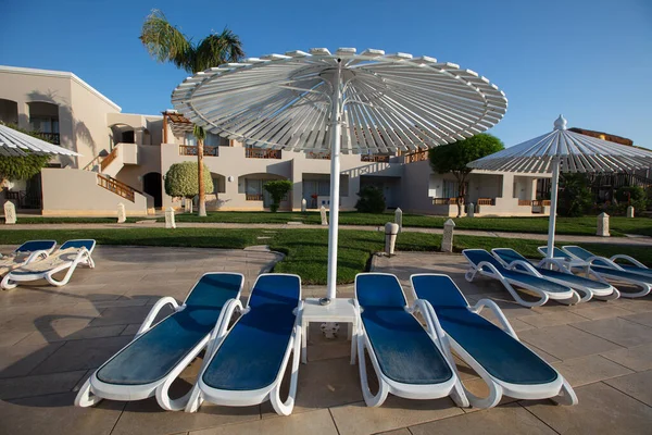 Hurghada, Egypt - October 1, 2019: sunshade umbrellas and sunbeds near pool in Jaz Casa Del Mar Resort in Hurghada, Egypt