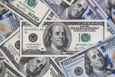 randomly layed 100 dollar bills background  for design purpose