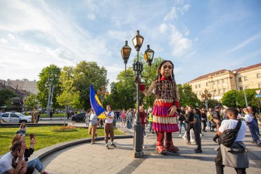 Lviv, Ukraine - May 11, 2022: Little Amal, a giant puppet representing a Syrian refugee girl, in Lviv, Ukraine