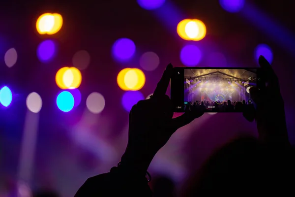 Hands with phones on concert, atmosphere on concert, stage lights