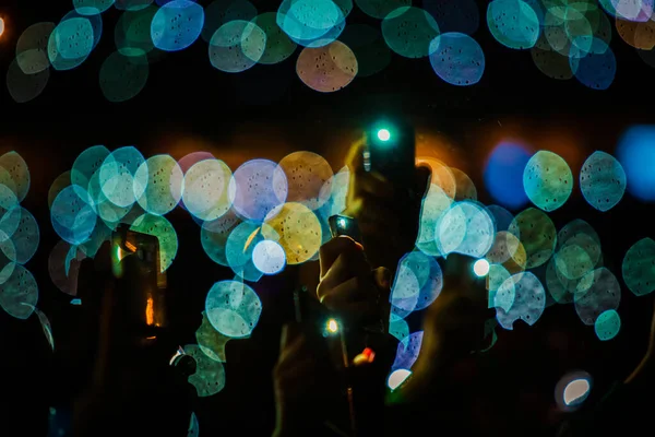 Hands with phones on concert, atmosphere on concert, stage lights