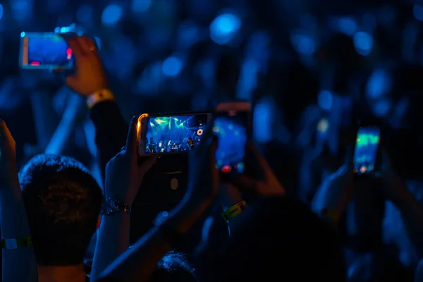 Hands with phones on concert, atmosphere on concert, stage lights