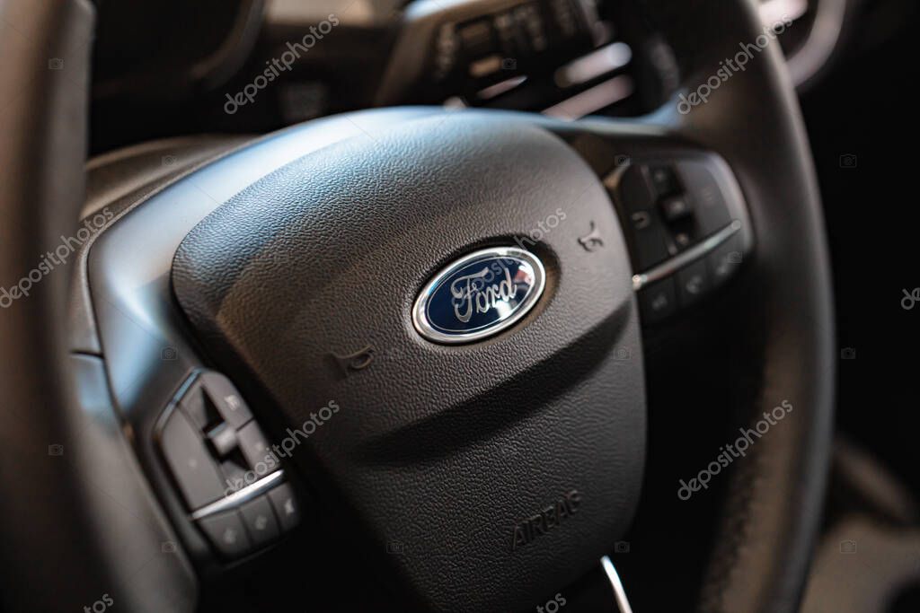 Lviv, Ukraine - October 17, 2022: Closeup of Ford logo on steering wheel
