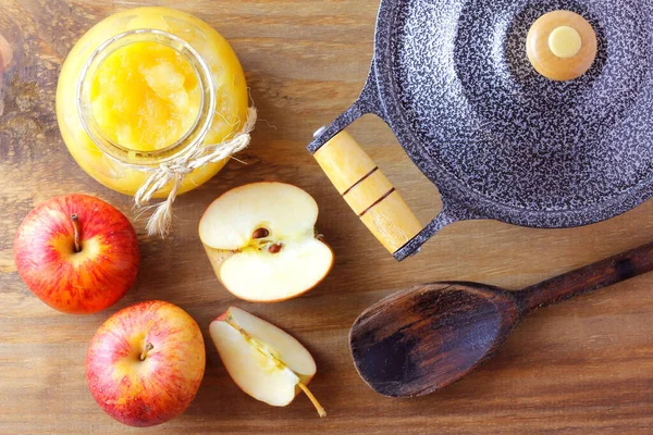 homemade apple sauce or apple puree in glass bowl over rustic wooden table. top view