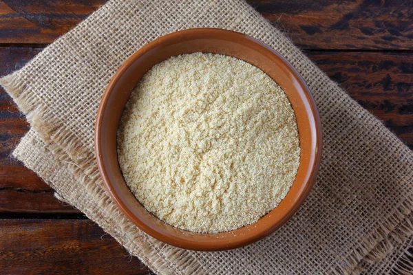 Toasted and crushed bread crumbs flour in ceramic bowl over rustic wooden table. Meat breading flour. Top view