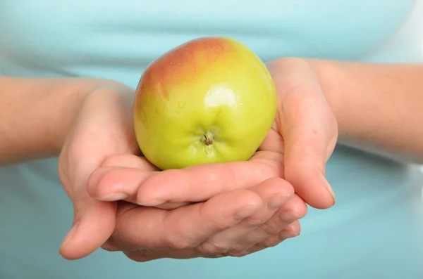 Has control over apple — Stock Photo, Image