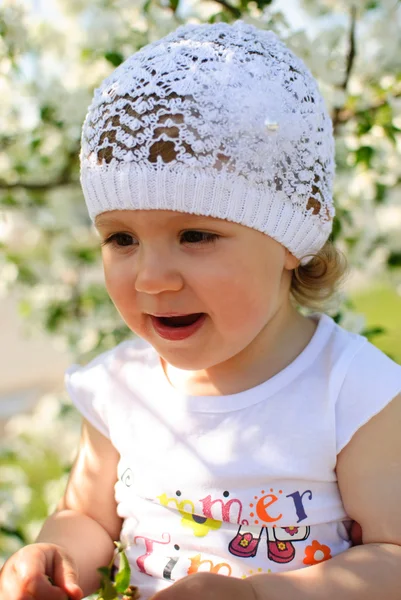 The child in flowers of an apple-tree — Stock Photo, Image