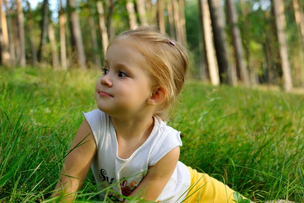 Portrait of the child on a grass — Stock Photo, Image