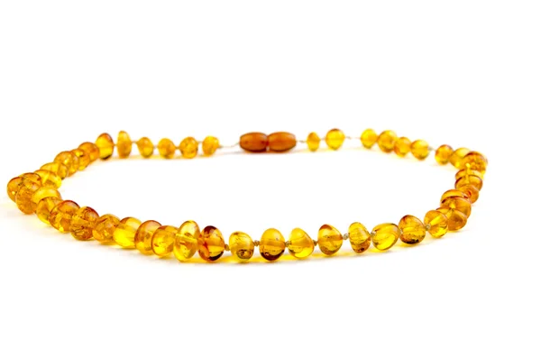 Closeup of an amber necklace on white background — Stock Photo, Image