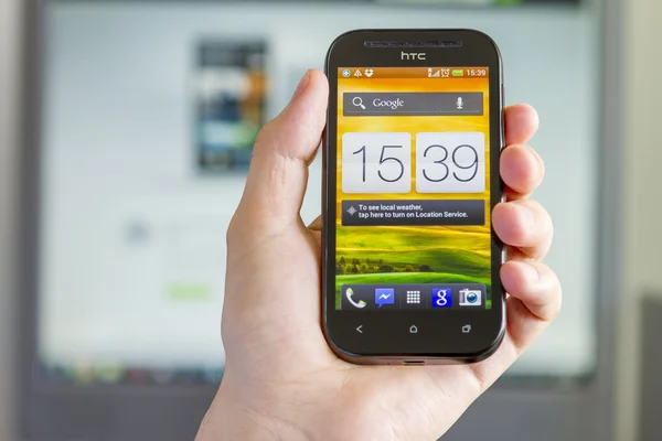 Closeup of Man's Hand holding a Smartphone in Office — Stock Photo, Image