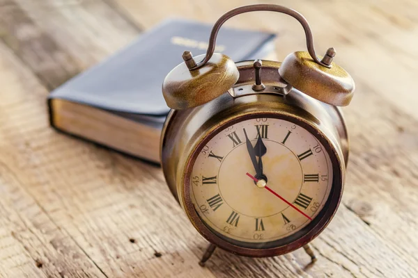 Clock and Bible on wood