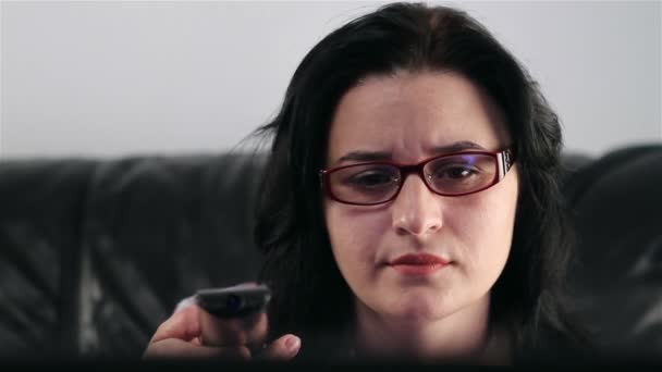 Молода жінка, спостерігаючи нудний фільм на ТБ — стокове відео