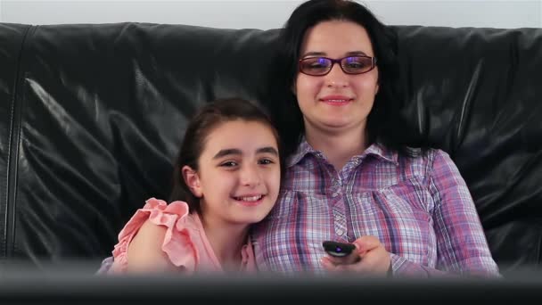 Young mother and daughter watching TV — Stock Video