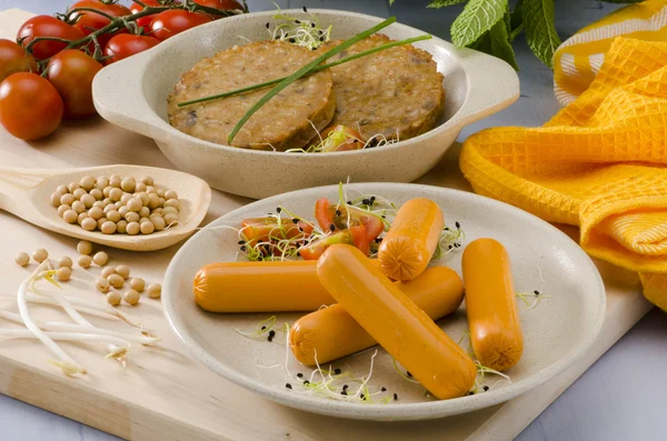 Vegetarian tofu burger and tofu sausage. — Stock Photo, Image