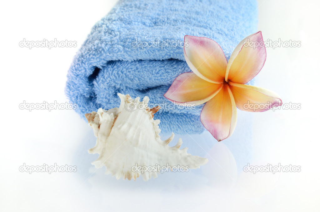 Blue towel with flower and sea shell