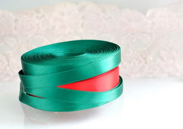 Green ribbon roll on a white background — Stockfoto