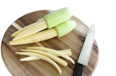 Baby corn on wooden, isolated white background