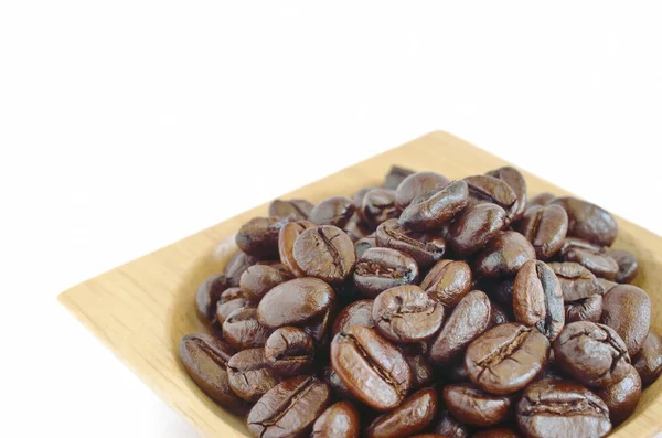 Grãos de café com xícara de madeira isolada no fundo branco — Fotografia de Stock
