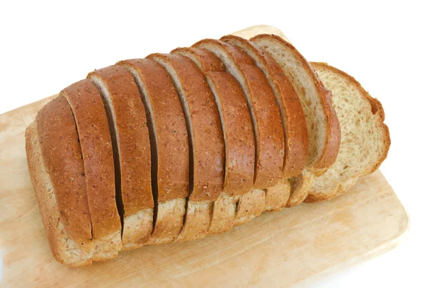 Sliced whole wheat bread on wood — Stock Photo, Image