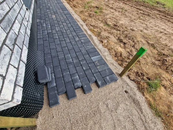 Dark concrete paving under construction in individual house