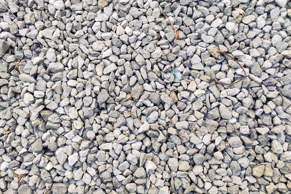 Small gravel road. Pebble background. Crushed stone texture. Gravel rock closeup ground