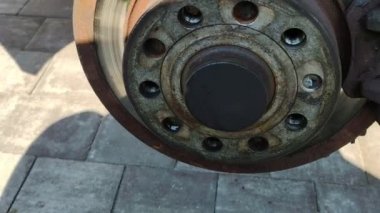 Old brake disc. Car disc brake repair. Vehicle service. Replacing parts by a mechanic